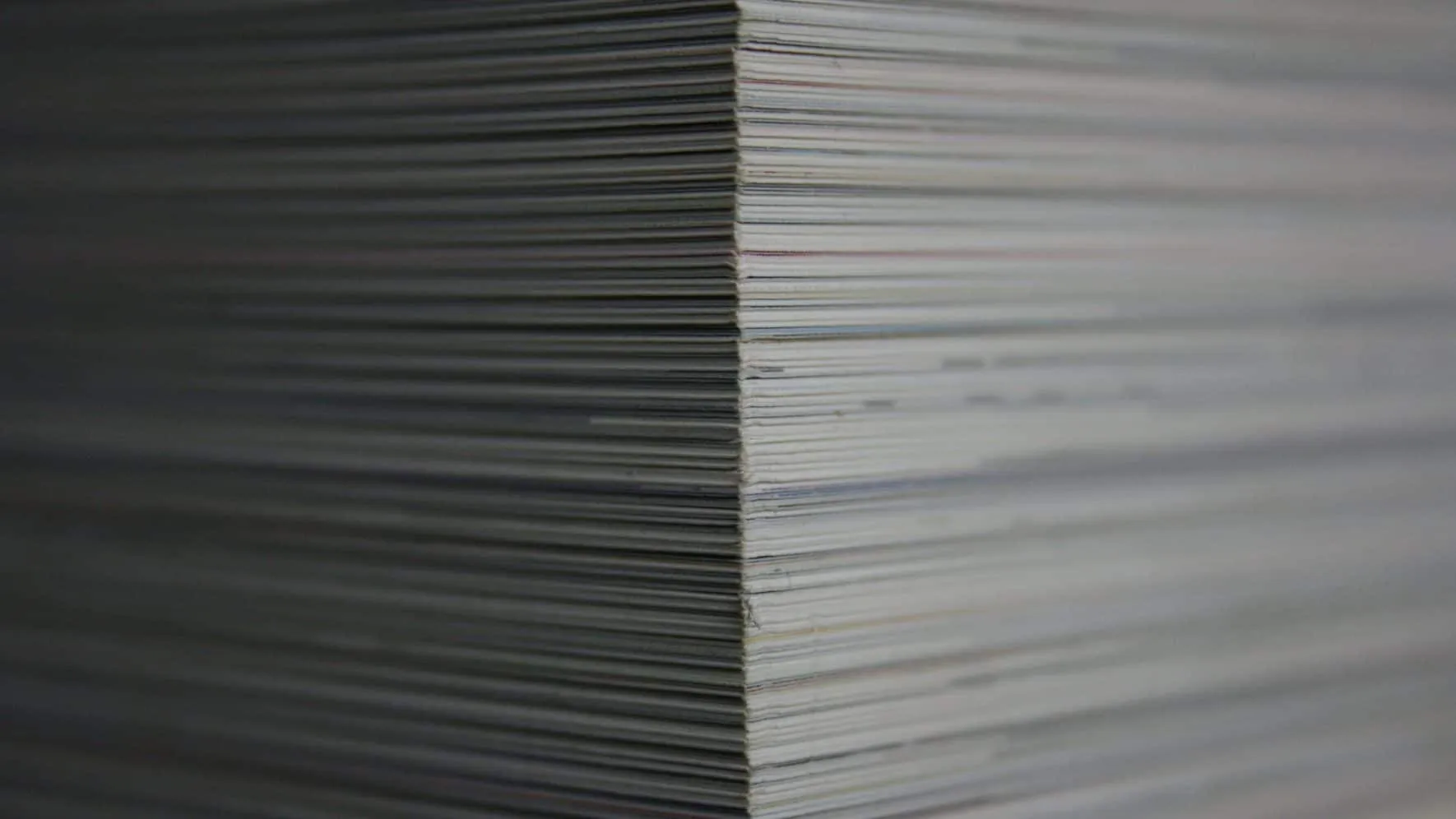 Tall stack of sheets of paper seen from the side
