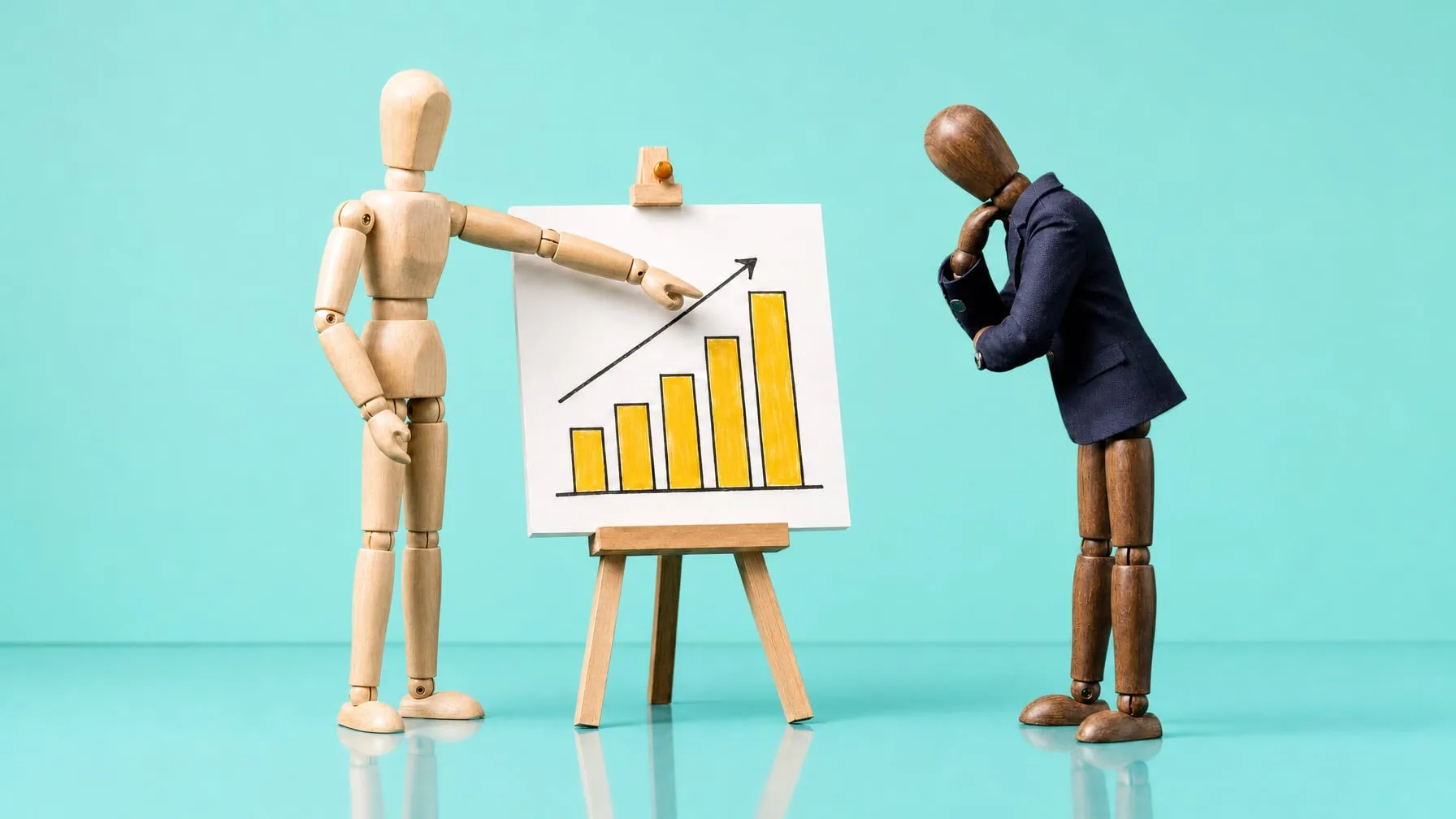 A pale wooden mannequin points at a bar chart with rising yellow bars while a dark mannequin in a blazer studies it thoughtfully